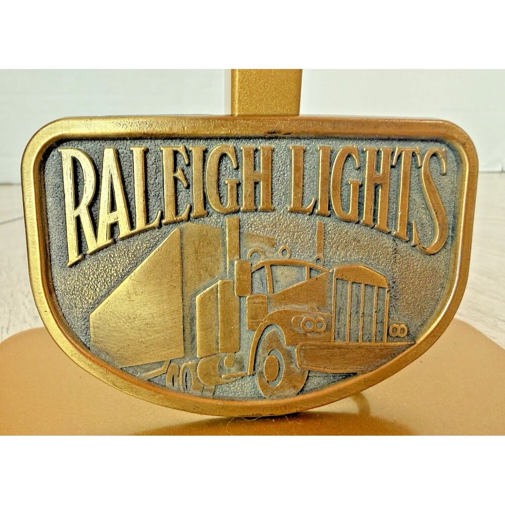 Vintage Raleigh Lights Belt Buckle 1970s Brass Tone Semi Truck Advertising USA